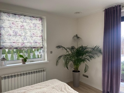 A modern living room with black curtians and black voile curtains