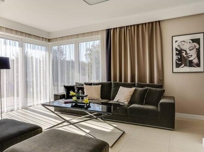 A modern living room with black curtians and black voile curtains