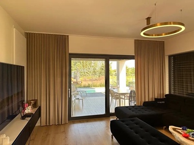 A modern living room with black curtians and black voile curtains