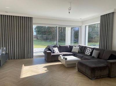 A modern living room with black curtians and black voile curtains