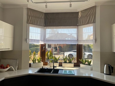 A modern living room with black curtians and black voile curtains