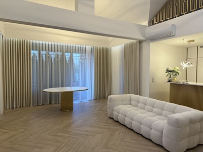 A modern living room with black curtians and black voile curtains