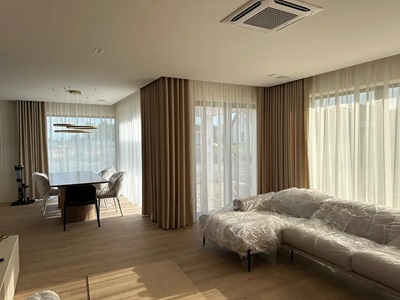 A modern living room with black curtians and black voile curtains