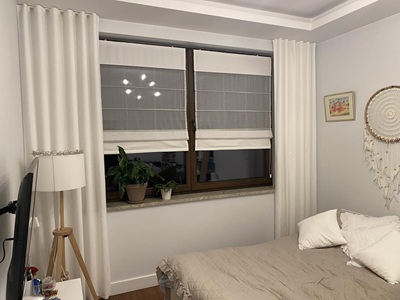 A modern living room with black curtians and black voile curtains