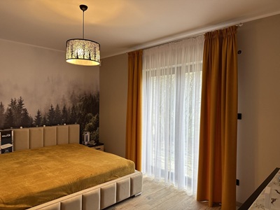 A modern living room with black curtians and black voile curtains